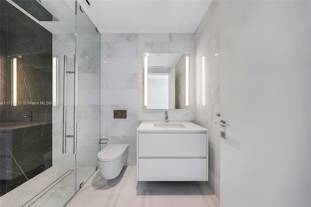 bathroom with tiled shower, vanity, toilet, and tile walls