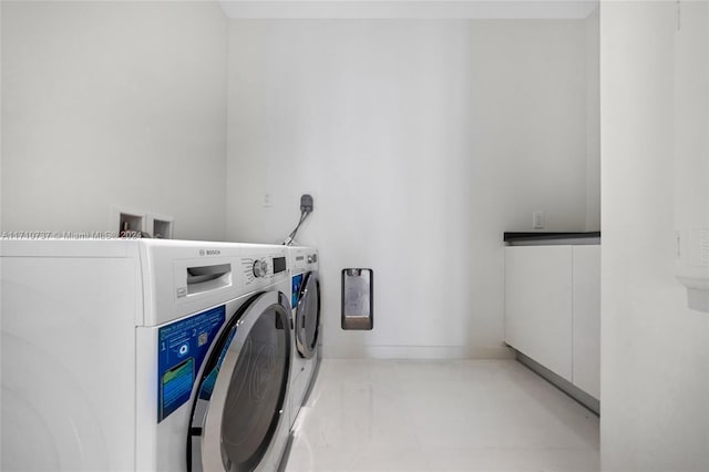 clothes washing area with separate washer and dryer