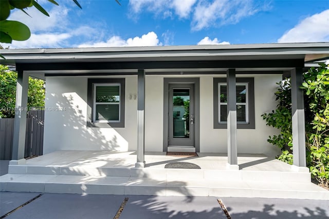 property entrance with covered porch