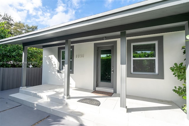 doorway to property featuring covered porch