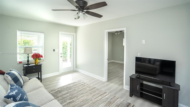 living room with ceiling fan and light hardwood / wood-style flooring