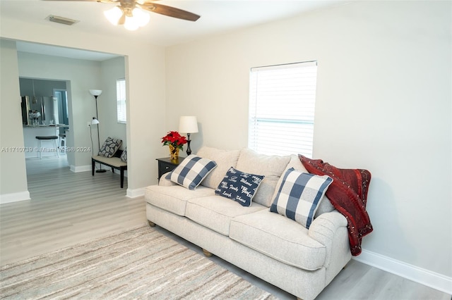 living room featuring ceiling fan, a healthy amount of sunlight, and light hardwood / wood-style flooring