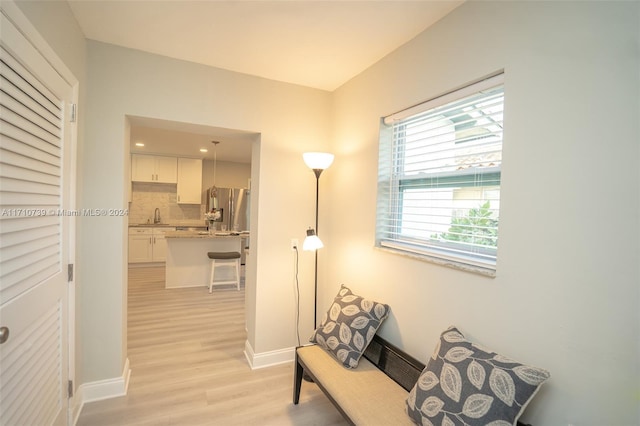 hall featuring sink and light hardwood / wood-style floors