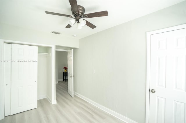 unfurnished bedroom with ceiling fan and light hardwood / wood-style flooring