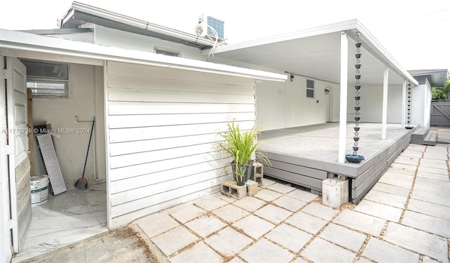 view of patio / terrace with a wooden deck and central AC