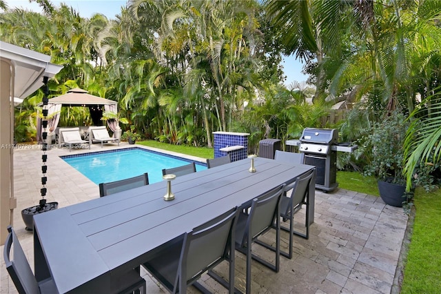 pool featuring outdoor dining space, a patio area, a grill, and a gazebo