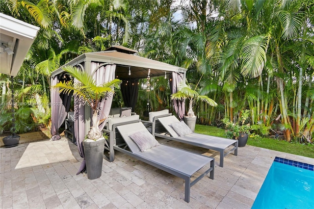 view of patio featuring an outdoor pool and a gazebo