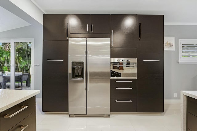 kitchen with appliances with stainless steel finishes and dark brown cabinetry