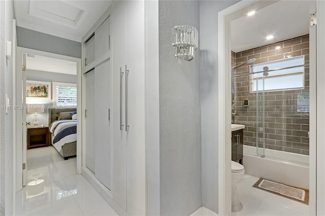 bathroom with ensuite bathroom, toilet, shower / bath combination with glass door, vanity, and tile patterned floors