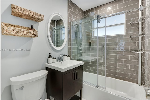 full bath featuring vanity, toilet, and bath / shower combo with glass door