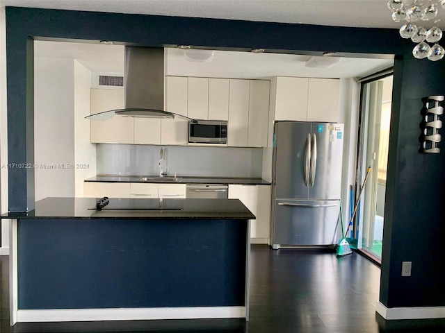 kitchen featuring white cabinetry, sink, dark hardwood / wood-style flooring, island range hood, and appliances with stainless steel finishes