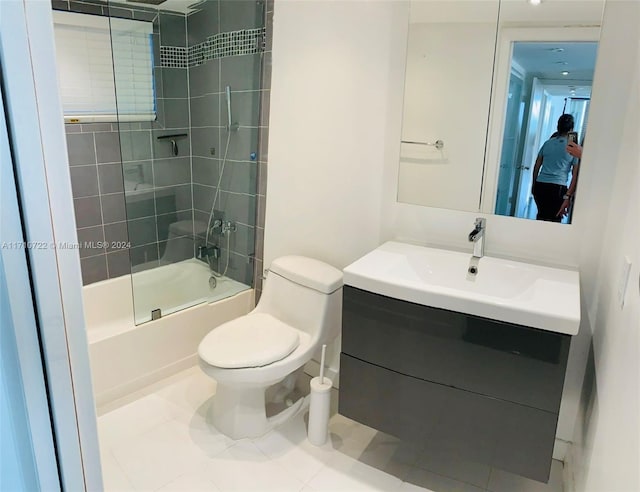 full bathroom with tile patterned flooring, vanity, toilet, and tiled shower / bath