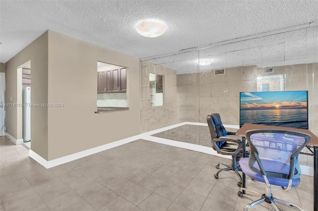 tiled office with a textured ceiling