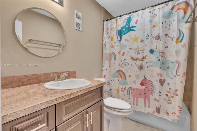 bathroom featuring vanity, a textured ceiling, and toilet