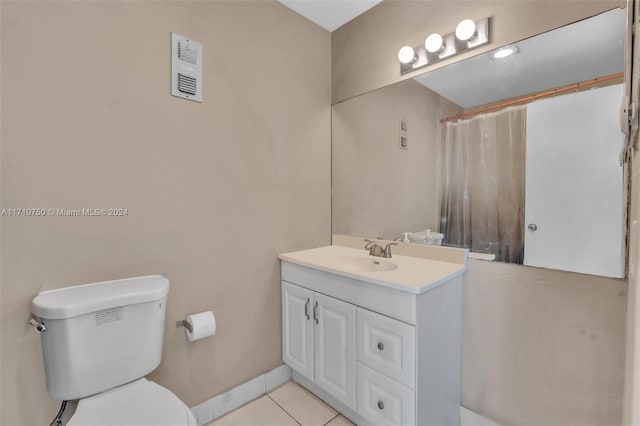 bathroom featuring tile patterned floors, vanity, and toilet