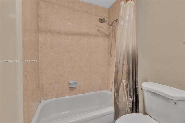 bathroom with toilet and shower / bathtub combination with curtain