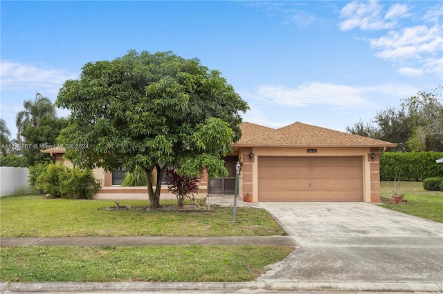 view of front of house with a front yard and a garage