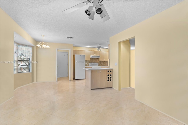 kitchen with white appliances, a textured ceiling, light brown cabinetry, tasteful backsplash, and a chandelier