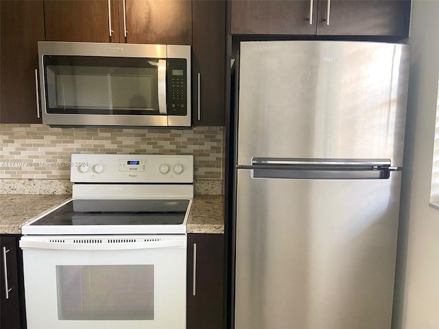 kitchen with dark brown cabinets, backsplash, and stainless steel appliances