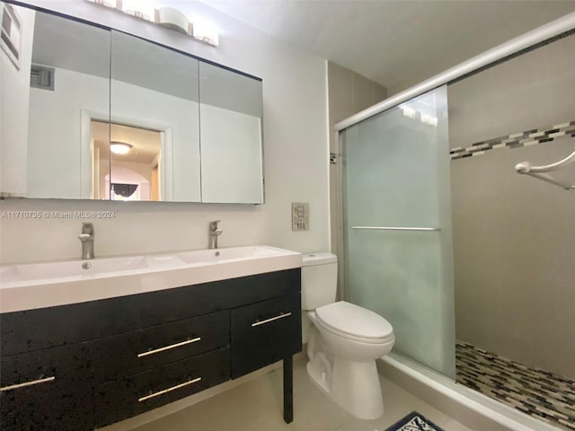 bathroom featuring vanity, toilet, and a shower with door