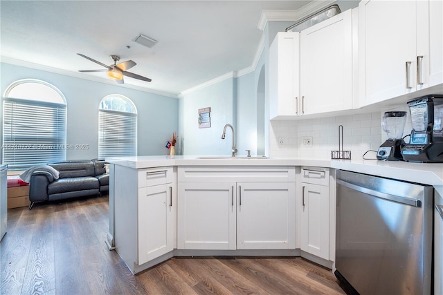 kitchen featuring stainless steel dishwasher, sink, white cabinetry, and kitchen peninsula