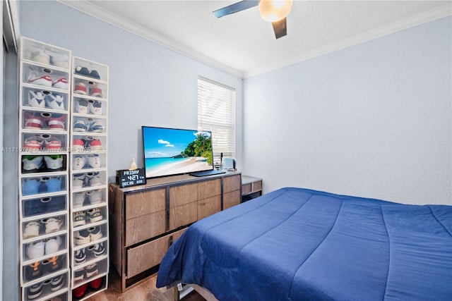 bedroom with ceiling fan and crown molding