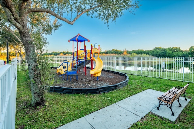 view of play area featuring a yard and a water view