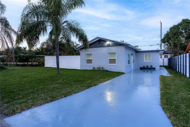 view of side of home featuring a lawn