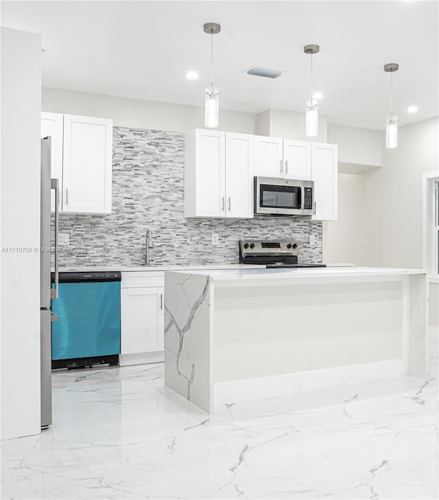 kitchen with decorative light fixtures, decorative backsplash, white cabinetry, and stainless steel appliances