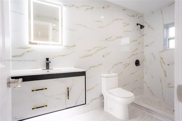 bathroom with vanity, toilet, and a tile shower