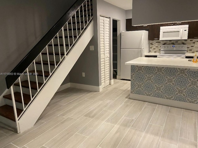 kitchen with white appliances and decorative backsplash