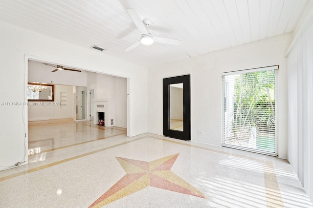 interior space with ceiling fan and wooden ceiling