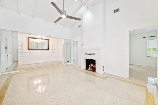 unfurnished living room featuring beamed ceiling, ceiling fan with notable chandelier, high vaulted ceiling, and wood ceiling