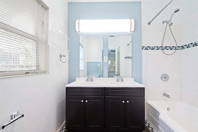 bathroom with vanity and tiled shower / bath combo