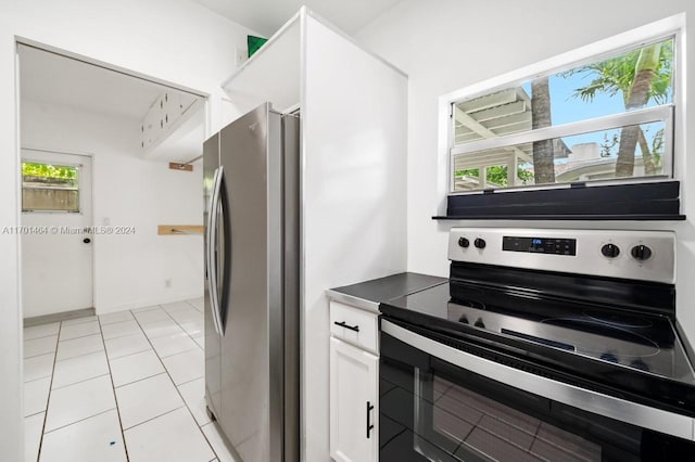 kitchen featuring white cabinetry, light tile patterned flooring, and stainless steel appliances