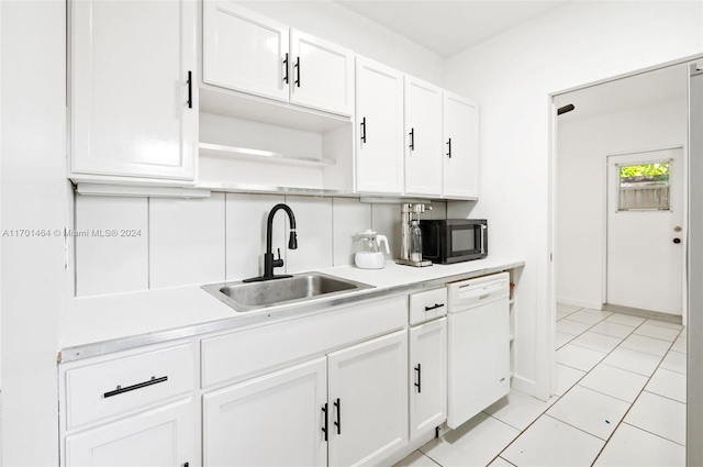 kitchen featuring light tile patterned floors, white dishwasher, white cabinetry, and sink