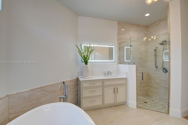 bathroom featuring vanity and shower with separate bathtub