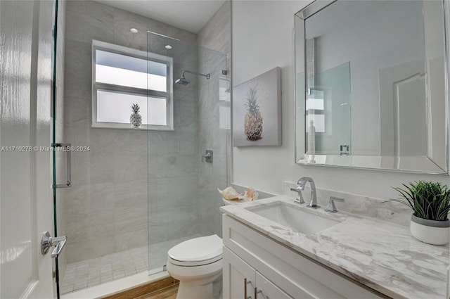 bathroom with a shower with shower door, toilet, wood-type flooring, and vanity