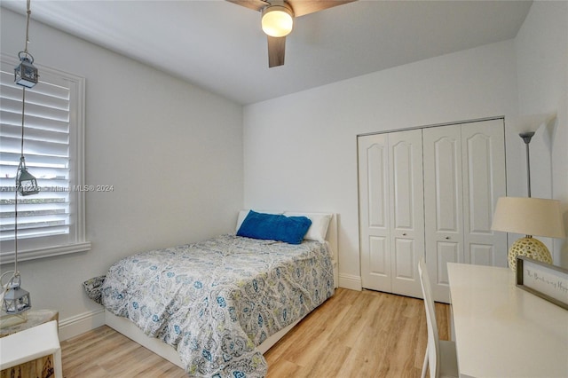 bedroom featuring ceiling fan, a closet, and wood-type flooring