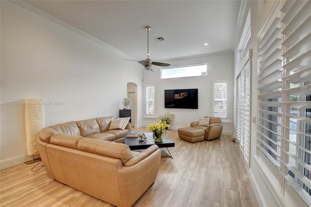 living room featuring light wood-type flooring, ceiling fan, and crown molding