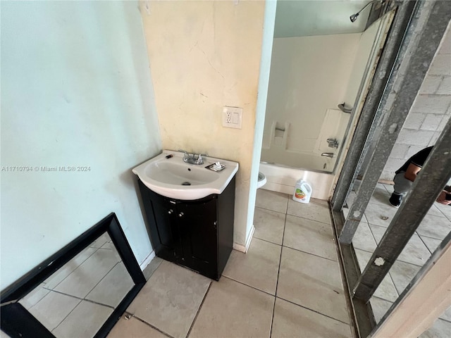 full bathroom featuring tile patterned floors, toilet, vanity, and bathing tub / shower combination