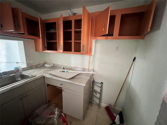 kitchen with sink and light tile patterned flooring