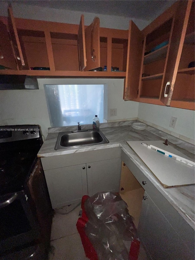 kitchen with black stove and sink