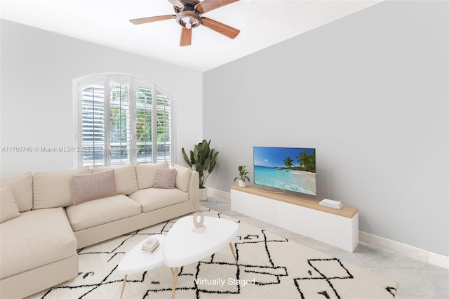 tiled living room with ceiling fan