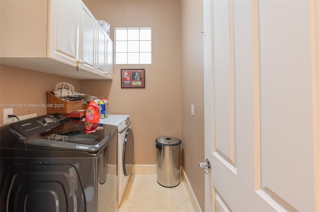 clothes washing area with cabinets, light tile patterned floors, and separate washer and dryer