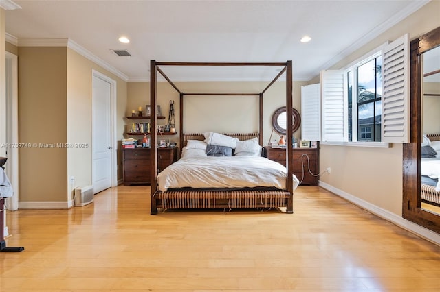 bedroom with light wood-type flooring and crown molding