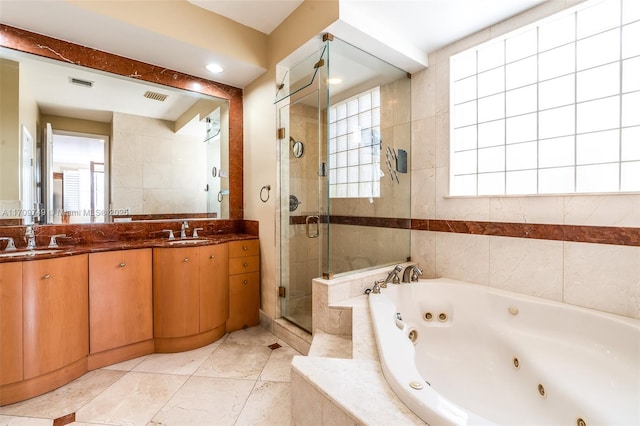 bathroom with vanity, tile walls, and separate shower and tub