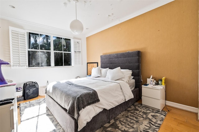 bedroom featuring hardwood / wood-style floors and crown molding