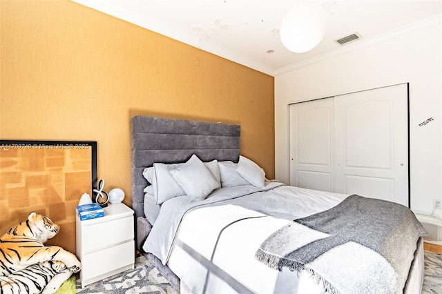 bedroom with a closet and ornamental molding