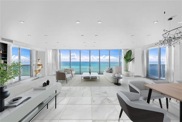 living room featuring floor to ceiling windows, a water view, and a healthy amount of sunlight